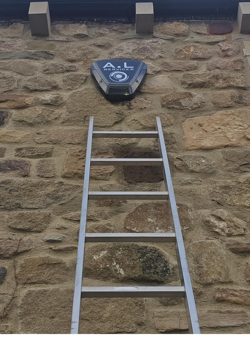 A.L Services bell box installed high on a stone farmhouse wall