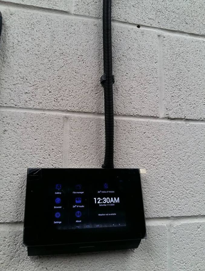 2N door intercom answering screen installed on a blockwork wall at a farm